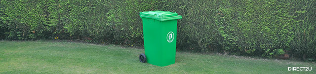 green wheelie bin against green backdrop